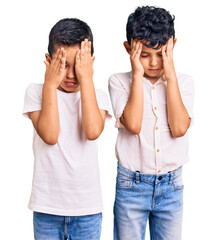 Couple of little brothers together wearing casual clothes suffering from headache desperate and...