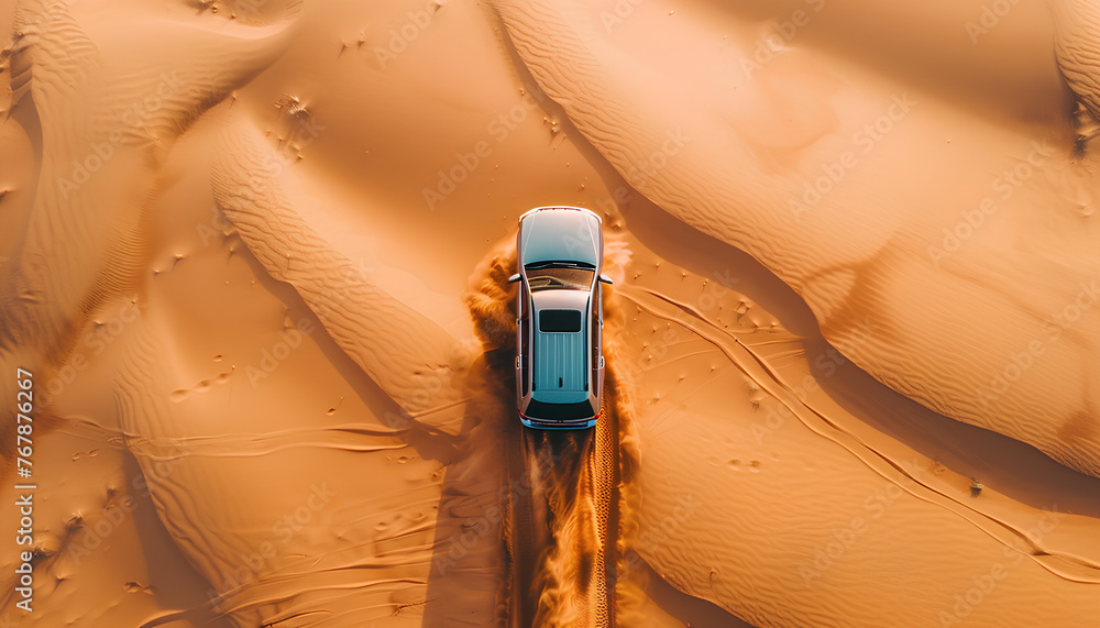 Poster car moves through deep sand in the desert top view