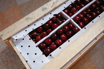 Cherries in a wooden box. The product is packaged for transport