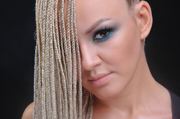 Portrait of a blonde with brown eyes with African braids
