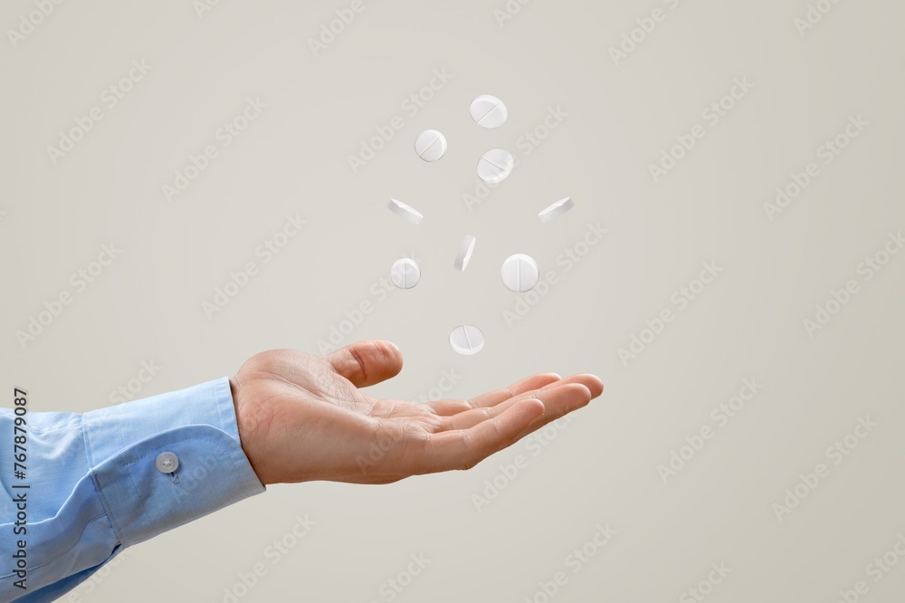 Canvas Prints Human hand holding a pill on background