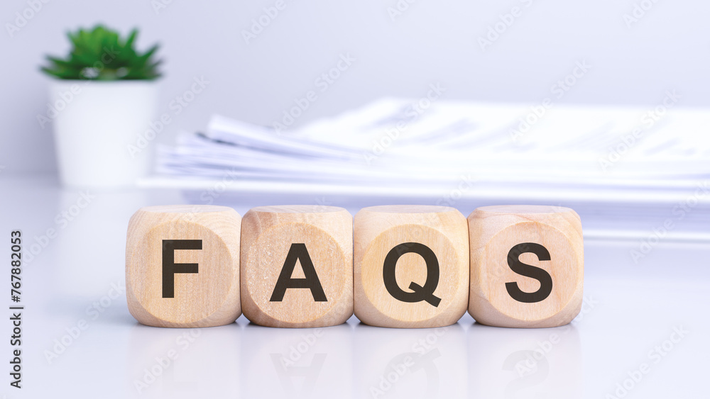 Poster the wooden cubes displaying the text 'faqs' against a light gray background signify a focus on blogg