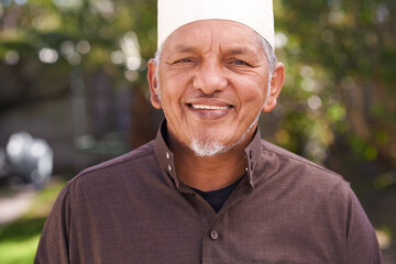 Happy, muslim and outdoor portrait of man with a smile in garden or relax on holiday in retirement....