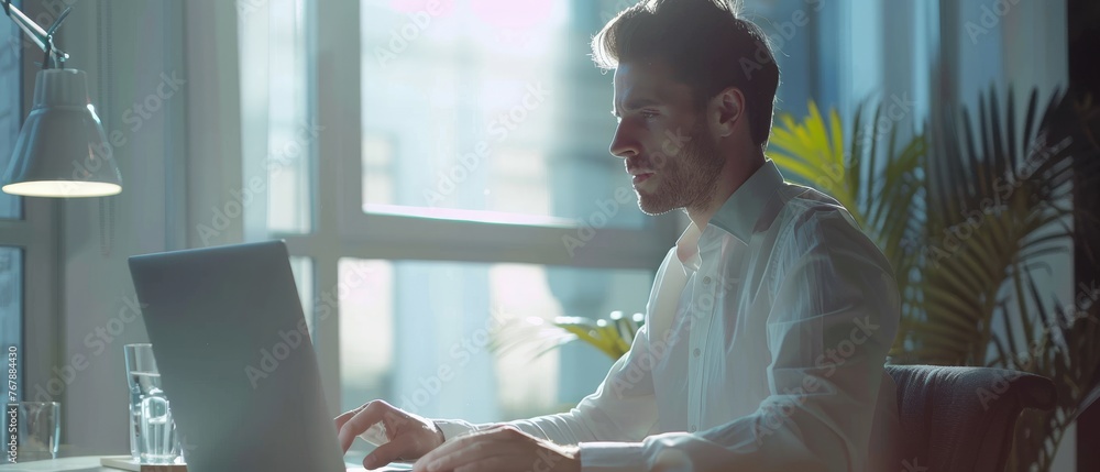 Poster the image depicts a busy young businessman using a laptop computer in a modern office. the manager i