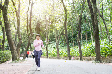 Fototapeta premium Woman exercising and jogging in park