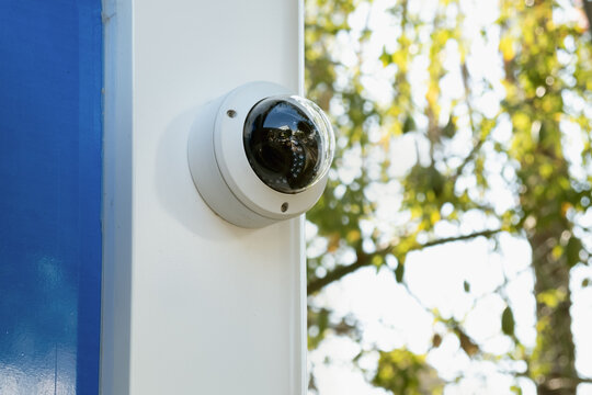 white CCTV camera camera on a street ATM. Providing security