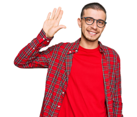 Hispanic young man wearing casual clothes waiving saying hello happy and smiling, friendly welcome gesture