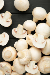 Fototapeta na wymiar Fresh white mushrooms champignon on black background.