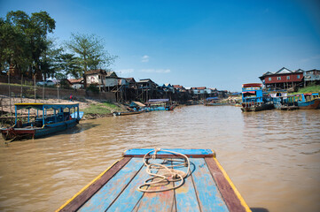 Wooden quay on muddy river water