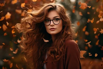 Foto auf Acrylglas Attractive brown hair woman wearing glasses against fall autumn ambience background, autumn scene, orange leaves © Daniel