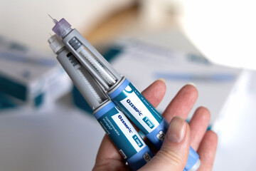 Hand holding Ozempic Insulin injection pen for diabetics. Denmark - March 25, 2024