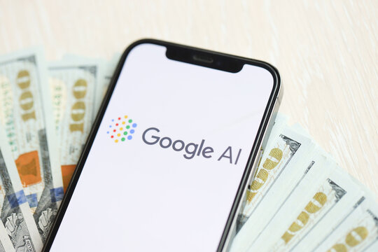 KYIV, UKRAINE - MARCH 17, 2024 Google AI logo on iPhone display screen with many hundred dollar bills. Artificial Intelligence engine