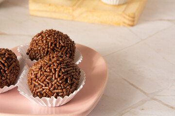 Chocolate truffle balls Brigadeiro brazilian candy and chocolate flakes front view clean background