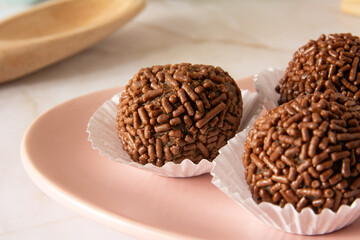 Chocolate truffle balls Brigadeiro brazilian candy and chocolate flakes front view clean background