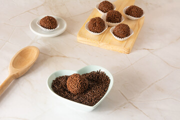 Chocolate truffle balls Brigadeiro brazilian candy and chocolate flakes front view clean background
