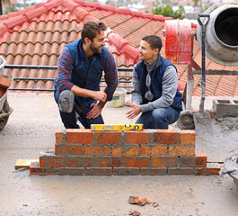 Construction worker, bricklayer and men building a brick wall, handyman or contractor with trade...