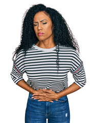 Middle age african american woman wearing casual clothes with hand on stomach because indigestion, painful illness feeling unwell. ache concept.