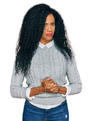 Middle age african american woman wearing casual clothes with hands together and crossed fingers smiling relaxed and cheerful. success and optimistic