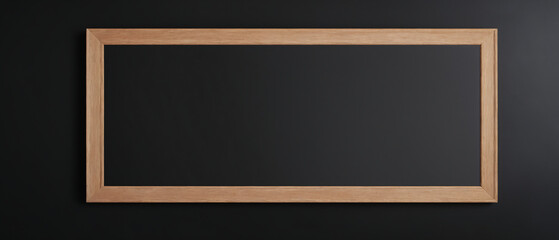 Blank black chalkboard mockup in wooden frame on black wall