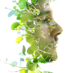 A close-up double exposure portrait of a man's profile in serene green colors