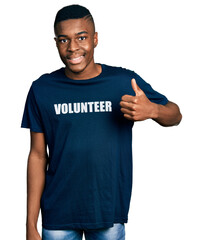 Young african american man wearing volunteer t shirt doing happy thumbs up gesture with hand. approving expression looking at the camera showing success.