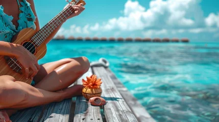 Fototapeten A singer playing a ukulele, sitting on a wooden dock with clear turquoise waters below, capturing the relaxed and laid-back vibe of tropical island music. © Daunhijauxx