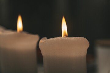 Close-up of a table with lit candles, illuminated in warm light