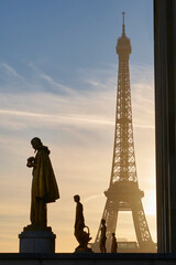 Fototapeta na wymiar Scenic view of sculptures against the Eiffel Tower at sunrise in Paris, France