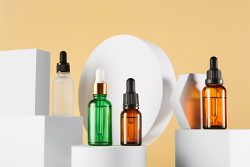 Dropper vials with serum are on white geometric shapes.