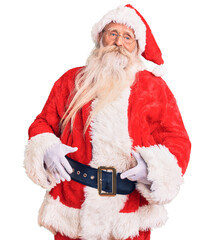 Old senior man with grey hair and long beard wearing traditional santa claus costume looking sleepy and tired, exhausted for fatigue and hangover, lazy eyes in the morning.