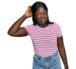 African young woman wearing casual striped t shirt confuse and wonder about question. uncertain with doubt, thinking with hand on head. pensive concept.