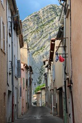 Fototapeta na wymiar Row of quaint buildings near a cliff in Sisteron, Provence, France