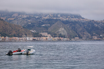 Obraz premium Ionian Sea seen from Giardini Naxos in the Metropolitan City of Messina on the island of Sicily, Italy. View with Villagonia - Taormina city