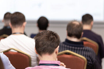 Back view of audience in a business conference or seminar.
