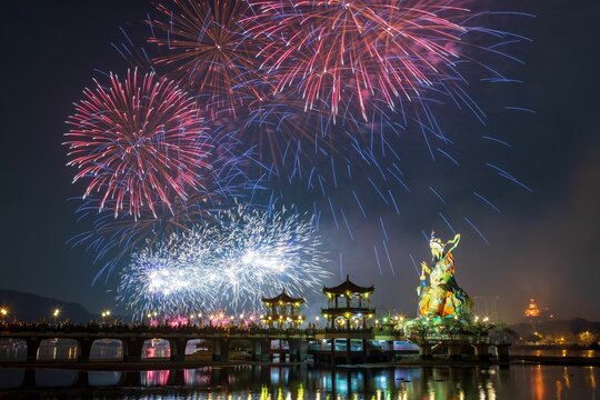 fireworks light up the sky over the water in this image