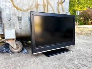 Old obsolete tv device by the trash container