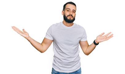 Young man with beard wearing casual white t shirt clueless and confused expression with arms and hands raised. doubt concept.