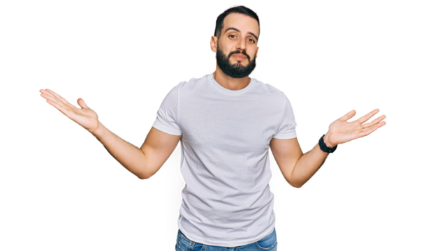Young man with beard wearing casual white t shirt clueless and confused expression with arms and hands raised. doubt concept.