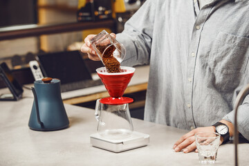 Expert Barista Prepares a V60 Pourover With Freshly Ground Coffee at Modern Coffee Shop, Close-up