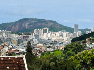 Fototapeta na wymiar Beautiful view of Sugarloaf Mountain (Morro do Pão de Açúcar), Baia de Guanabara, Niterói, Morro dos Prazeres favela, from a viewpoint in Parque das Ruínas - Rio de Janeiro, Brazil
