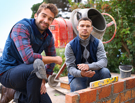 Bricklayer, working and construction with men builder, maintenance employee and cement machine for industrial job. Foreman, contractor together in renovation career, handyman with tools on site