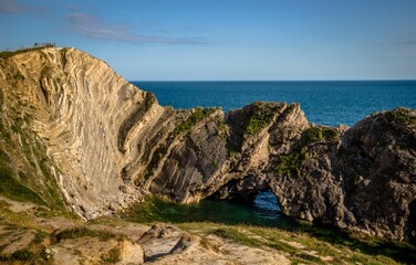 Stunning coastal landscape featuring a rocky cliff and waters in Stair Hole, Dorset, England