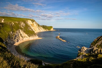 Stunning landscape of a beach on a sunny day in in Man o' War Cove, Dorset, England