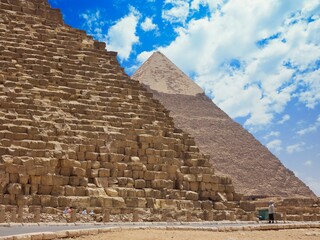 Scenic view of two large pyramids of Giza on under a cloudy sky
