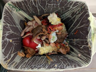 Domestic compost garbage bin with food waste in a restaurant