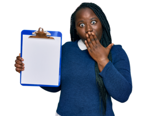 Young black woman with braids holding clipboard with blank space covering mouth with hand, shocked and afraid for mistake. surprised expression