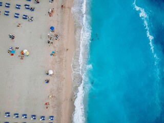 Aerial view of a beach with people enjoying the sun and sea