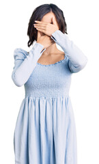 Fototapeta premium Young beautiful girl wearing casual clothes covering eyes and mouth with hands, surprised and shocked. hiding emotion