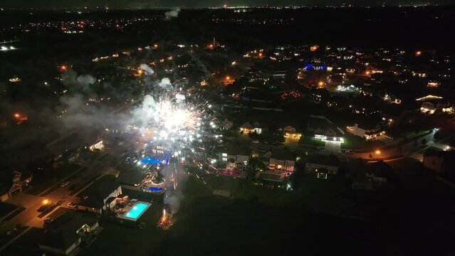 Aerial view of city at night with colorful glowing fireworks at night