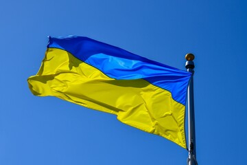 Ukrainian flag waving in the wind on a bright, sunny day.